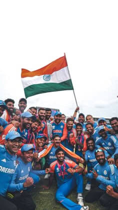Indian cricket team celebrating a victory with the national flag after a major cricket tournament match, showcasing unity and national pride.