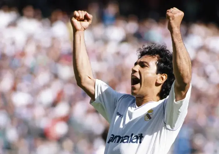 Hugo Sánchez celebrating a goal in a white Real Madrid jersey, capturing the excitement of La Liga betting.
